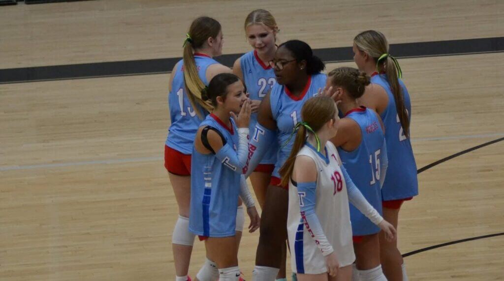 Thrasher volleyball players huddle together during a 2026 match